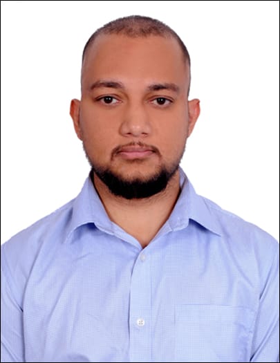 Professional headshot of Indian man in navy blue suit with confident smile